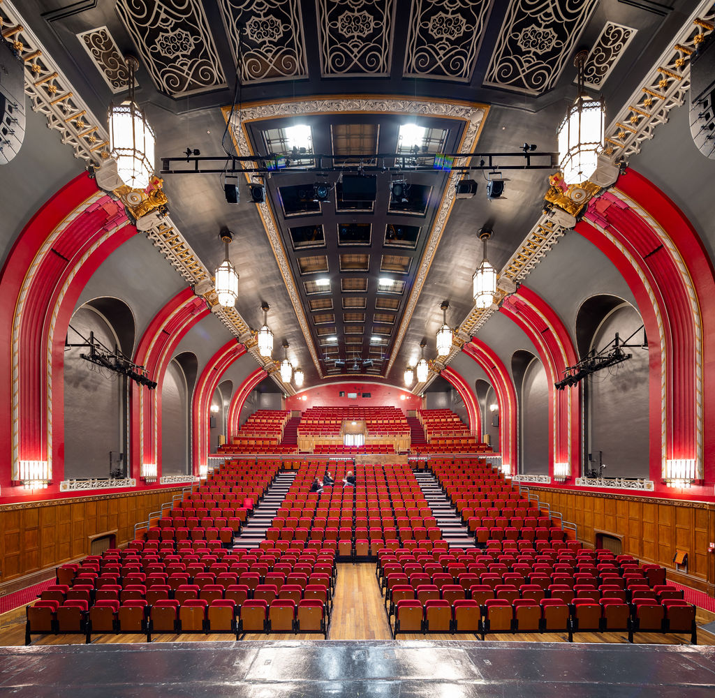 The Broadway Theatre in Catford has recently re-opened following a major refurbishment. The Grade ll* listed theatre closed during the Covid pandemic, and Lewisham Brough Council used this time to invest in key improvements, particularly improving accessibility to the theatre. The refurbishment works was designed by Purcell and carried out by Rooff and included upgraded seating and an overhaul for the main auditorium, a new bar area, decoration works and new digital signage on the outside of the building. New mechanical, electrical and fire alarm systems have been installed to help improve the Council’s carbon footprint and bring the facilities up to date. Accessibility improvements throughout the whole theatre means that performers are now able to access both eh stage and the dressing room areas, alongside better access for the public. Client: Lewisham Borough Council / London Borough of Lewisham. Architect: Purcell. Main Contractor: Rooff. Engineers: Integral Engineering Design. Theatre Designers: Charcoalblue